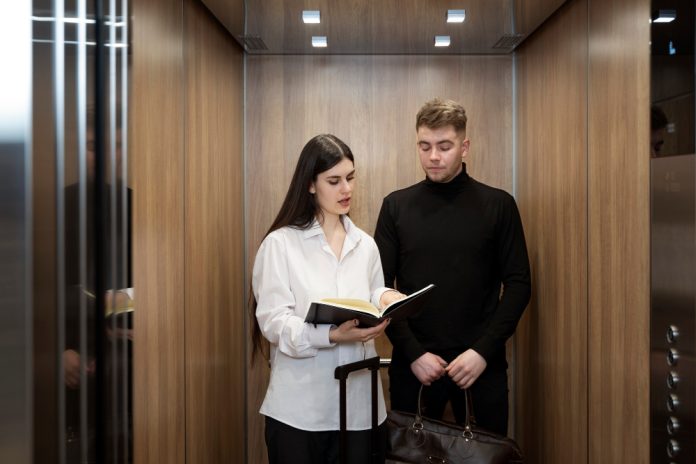 young-woman-young-man-talking-elevator-hotel